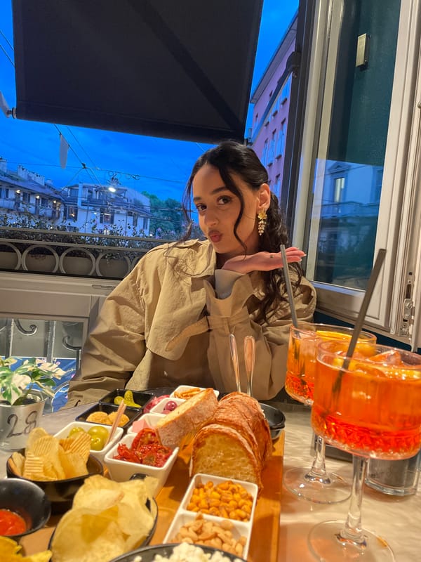 Woman documents aperitivo hour with cocktails in Milan