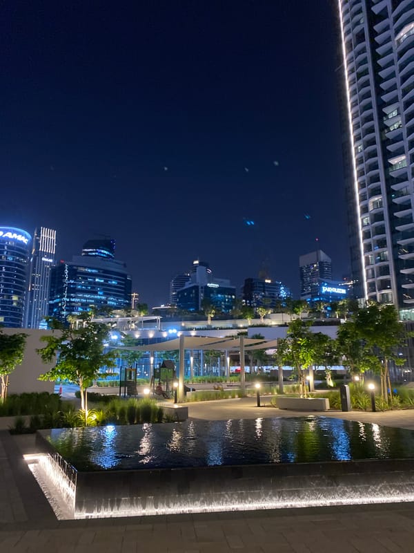Nighttime urban scene observed in Dubai featuring illuminated buildings