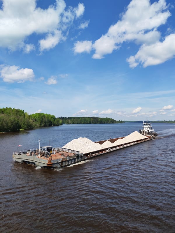 Commercial barges transport materials along Russian river near Kurikaevo