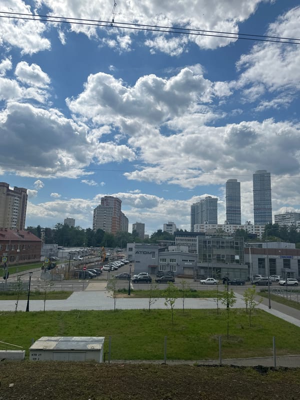 Moscow street scene shows bright partly cloudy daytime conditions