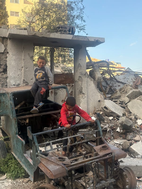 Children play in damaged vehicle amid Gaza destruction