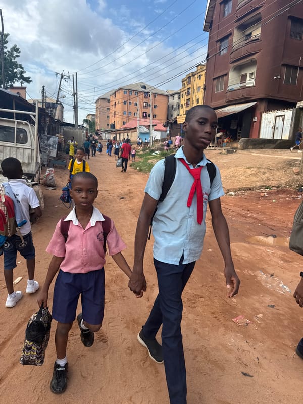 Schoolchildren heading home through Onitsha's dusty streets