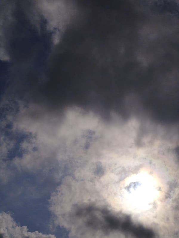 Sun breaks through clouds at unknown location