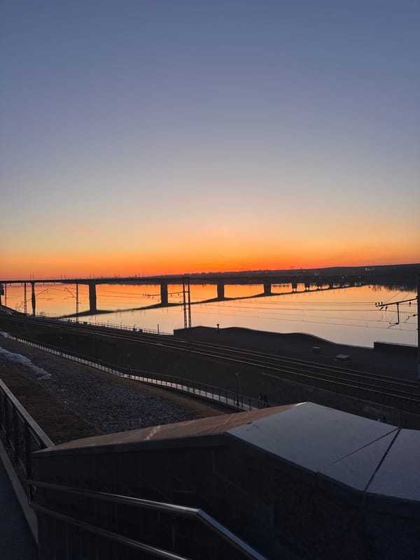 Sunset illuminates railway bridge over Kama River in Perm