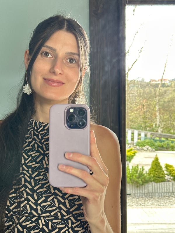 Woman takes selfie, hyacinth flowers displayed in Wisła, Poland