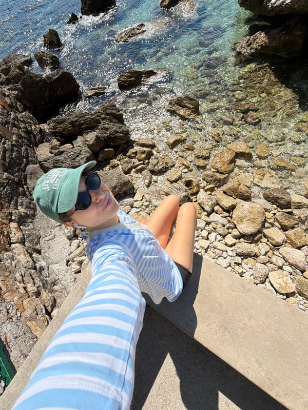 Tourist captures seaside selfies along Budva's rocky Montenegro coastline
