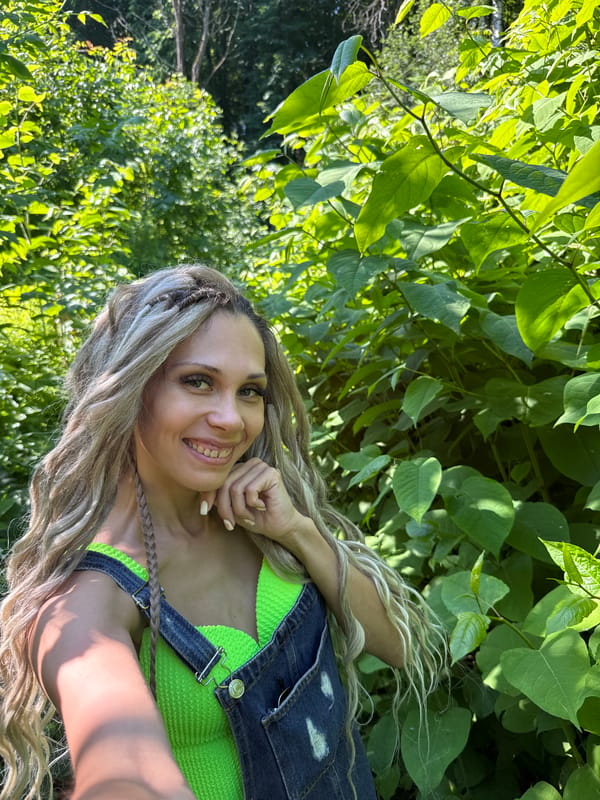 Woman takes forest selfies in early morning near Rusanovo