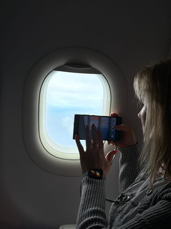 Airline passenger films sky view through window near Portugal