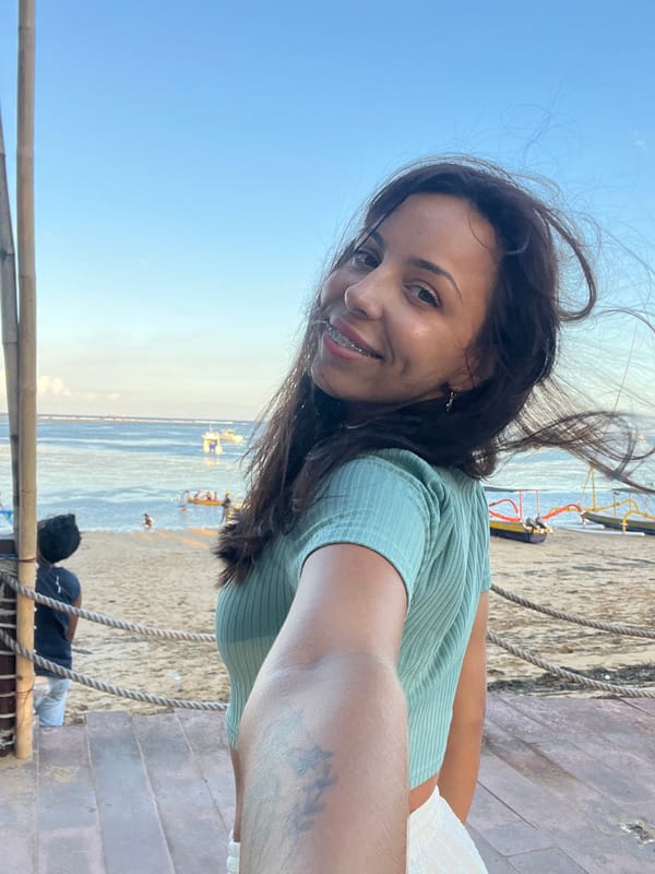 Woman takes selfie at Denpasar beach location