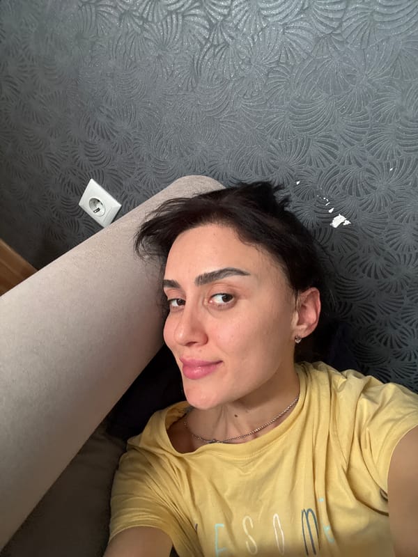 Person in yellow shirt captured in quiet moments around Tbilisi home