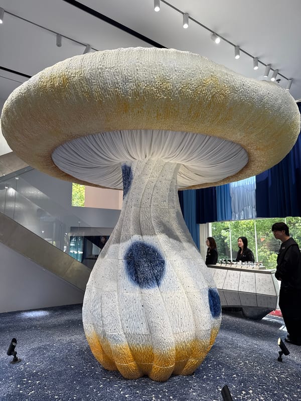 Urban scenes documented: mushroom sculpture, woman in denim, brick building