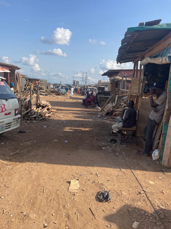 Outdoor marketplace activity documented in Abuja industrial district