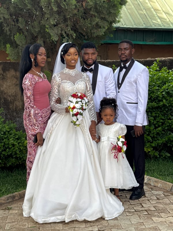 Wedding party poses for outdoor photographs in Jos, Nigeria