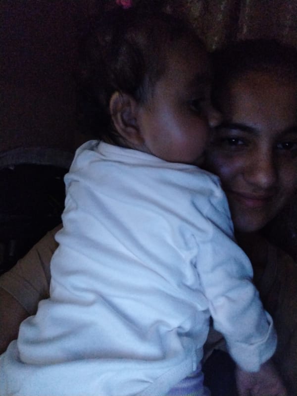 Mother and infant share quiet moments on sofa