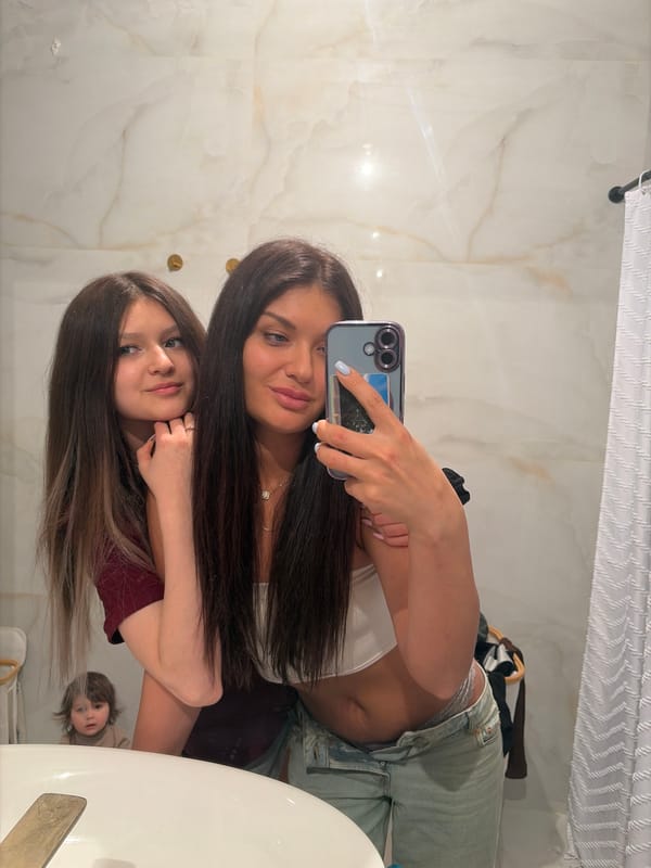 Two women take bathroom selfies in Moscow