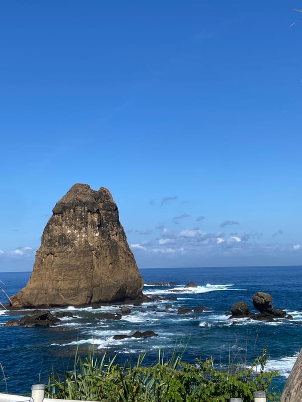 Tourists enjoy scenic coastal views at Indonesian lookout point