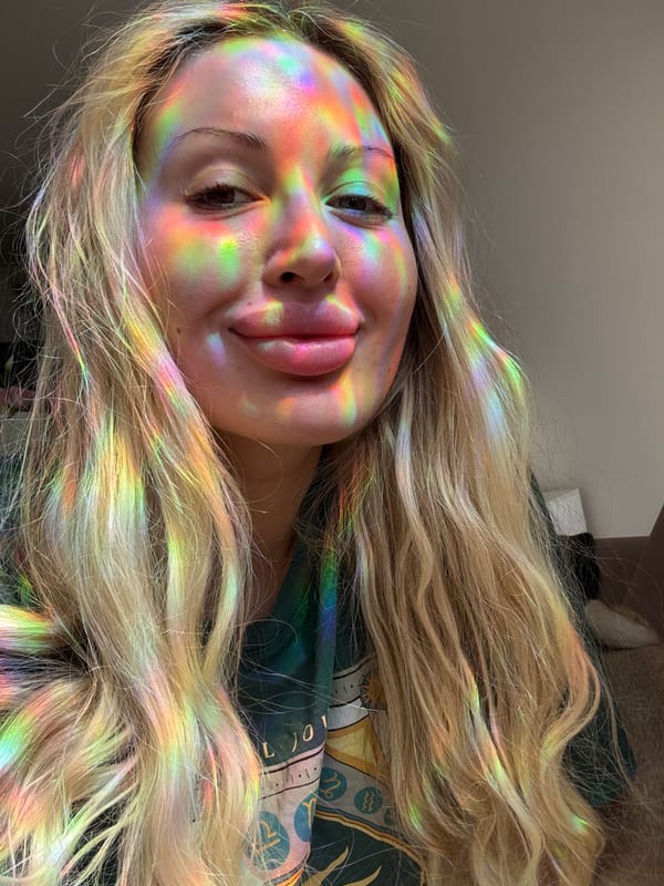 Close-up portrait lit by colorful, patterned light