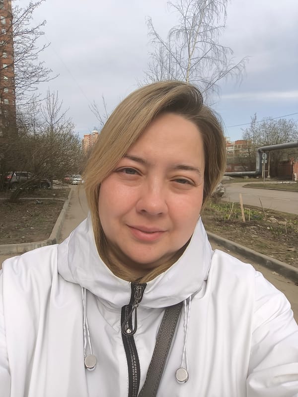 Woman takes morning selfie on Khimki sidewalk