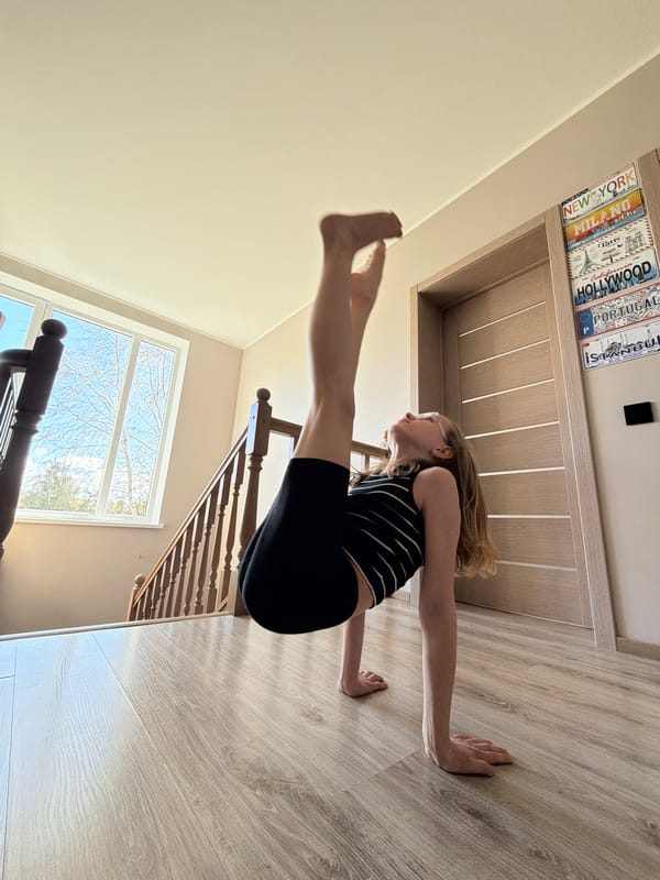 Woman performs gymnastics routine indoors in Dreiliņi, Latvia