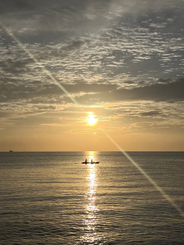 Boats, a sunset paddle, and a passing jet over Ko Samui