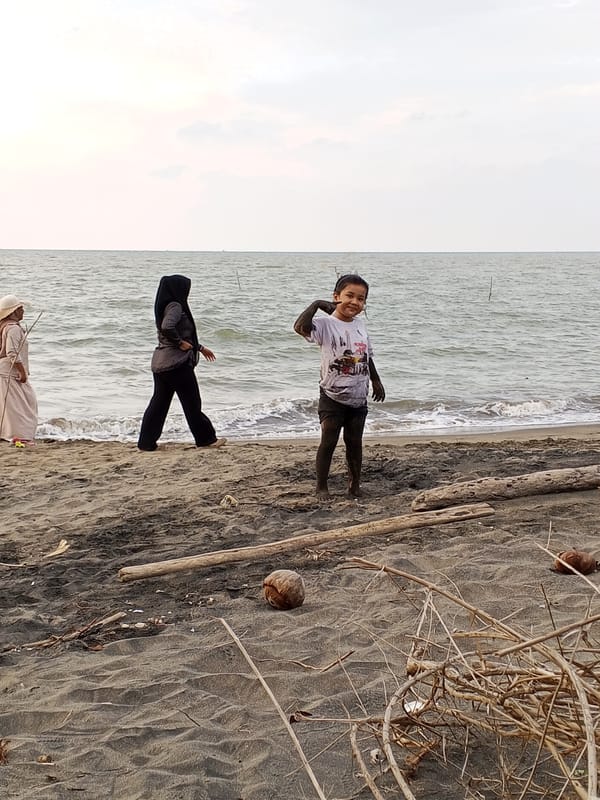 Mud-covered beach moment on the shores of Lhokseumawe