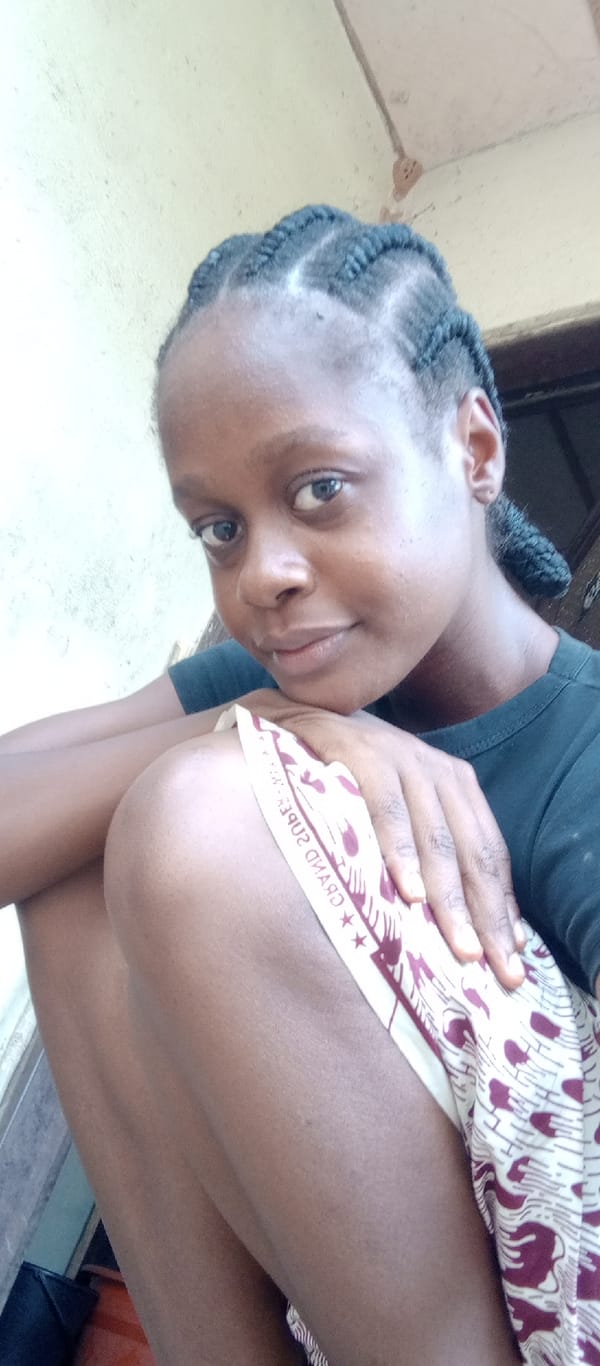 Young woman photographed smiling at camera in casual portrait