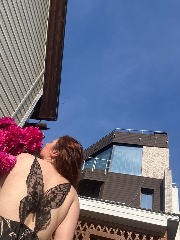 Mother and toddler share peony flowers in Nizhny Novgorod