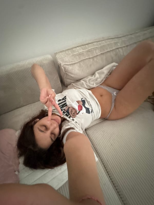 Woman takes relaxed selfies on sofa in Mönchengladbach