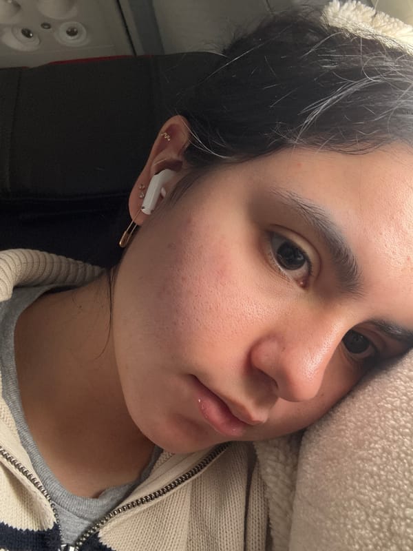 Young woman photographed wearing earbuds and jewelry in Maramec