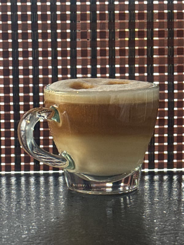 Coffee moment captured on checkered surface April 20