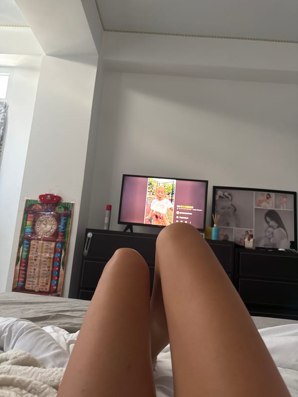 Quiet afternoon in a Chișinău bedroom, TV on, kid watching cartoons