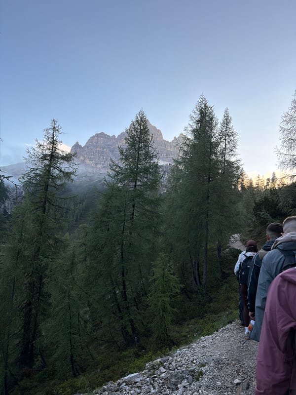 Early morning hikers traverse mountain trails in Italian Alps