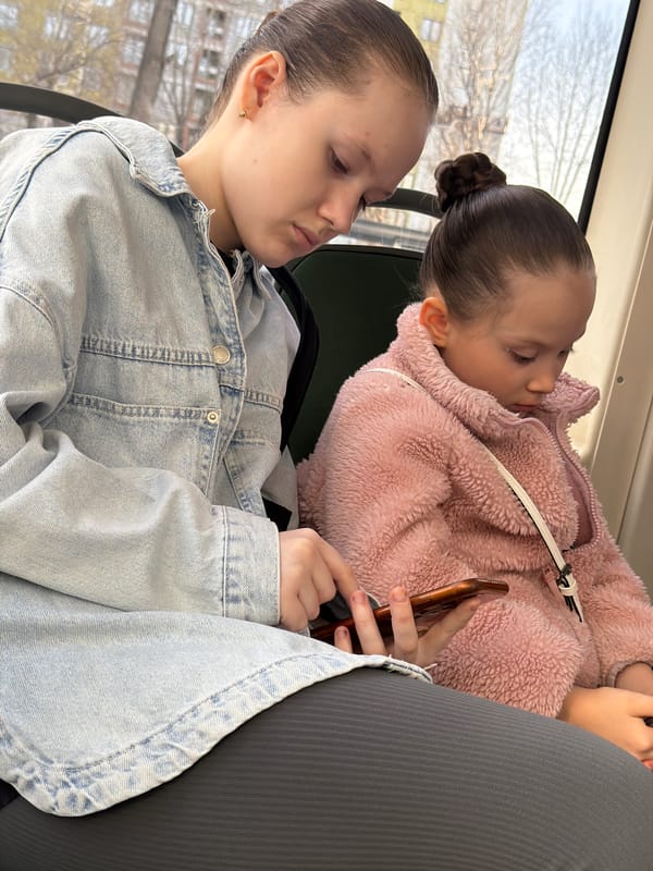 Two girls ride bus together in Perm, Russia