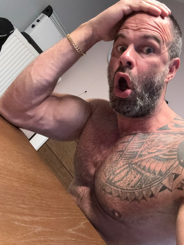 Man with chest tattoo photographed indoors in Belgian town