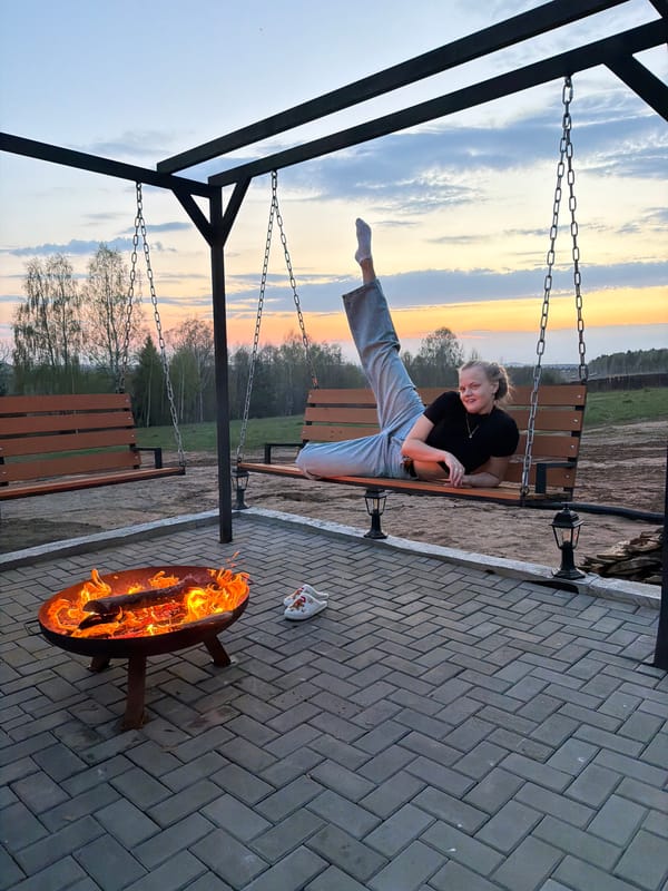 Woman enjoys evening fire pit gathering in Kamennoye, Russia