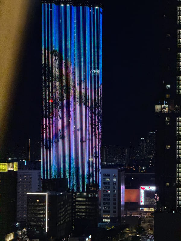 Kuala Lumpur skyline observed with illuminated tower, crescent moon