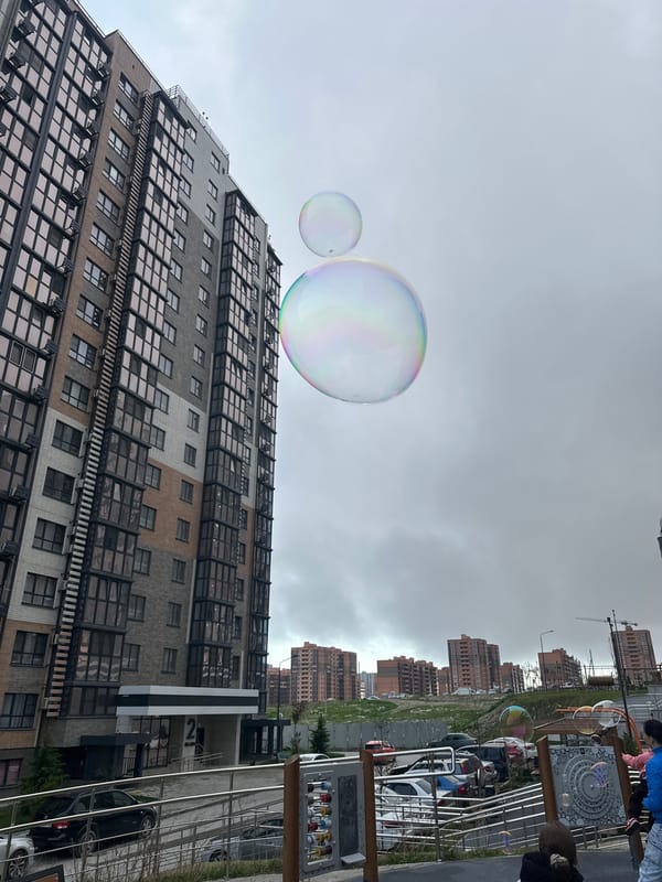Soap bubbles float on overcast street in Novorossiysk