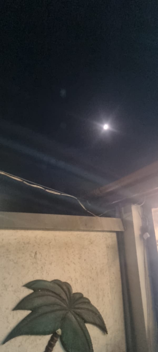 Witnesses document moonlit city scenes during May evening hour