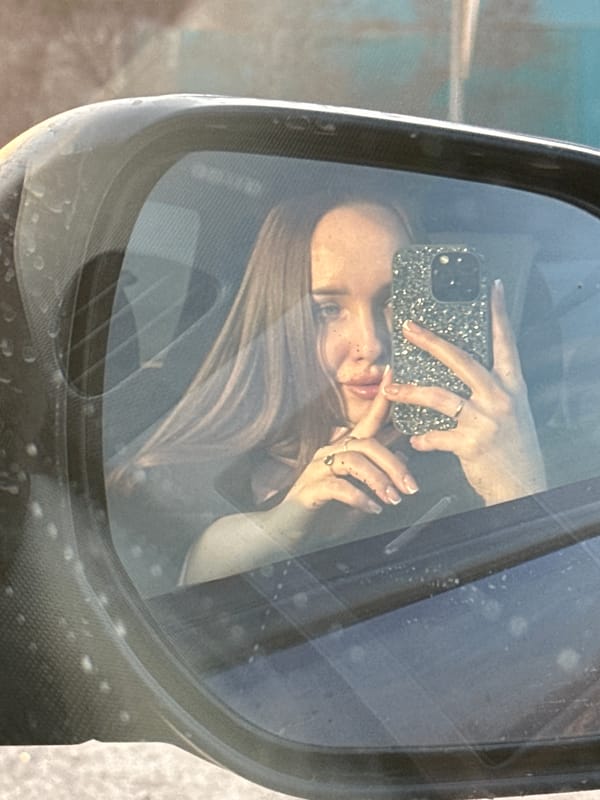Woman takes selfie in car in Pirogovo, Russia