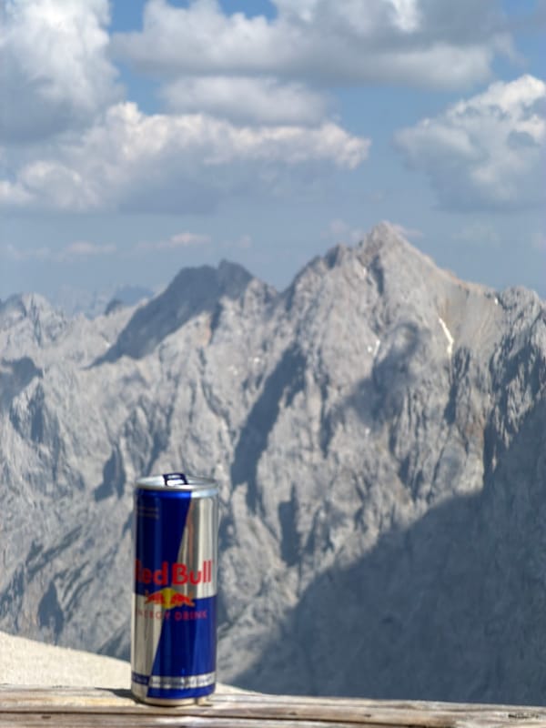 Red Bull can posed against Bavarian alpine scenery