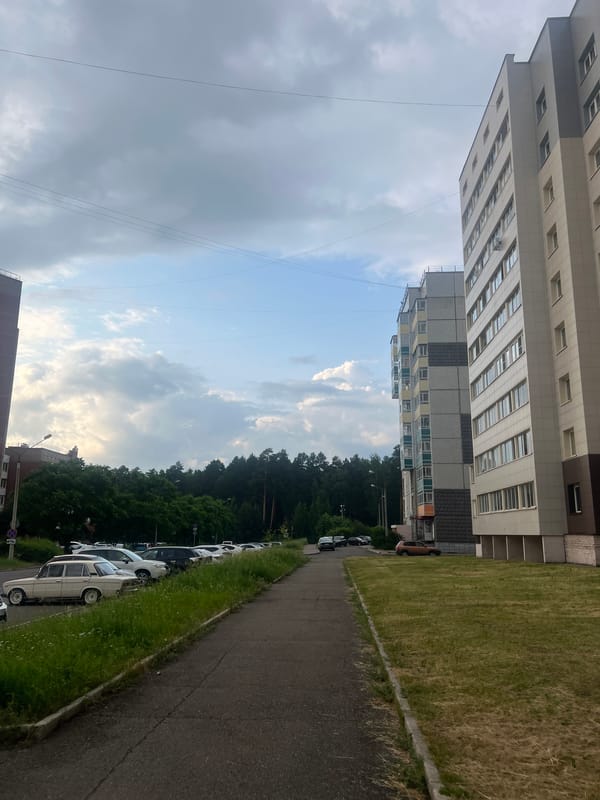 Everyday street life across Zheleznogorsk on a cloudy June afternoon