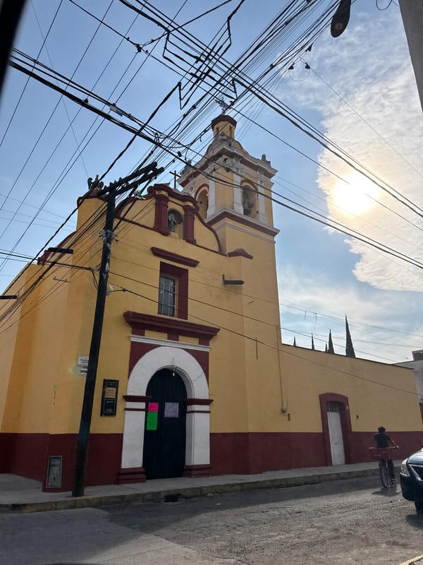 Yellow church with bell tower photographed in Cholula, Mexico