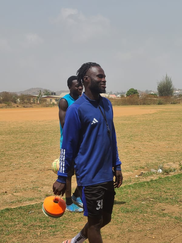 Young men gather for sports training in Nigerian field