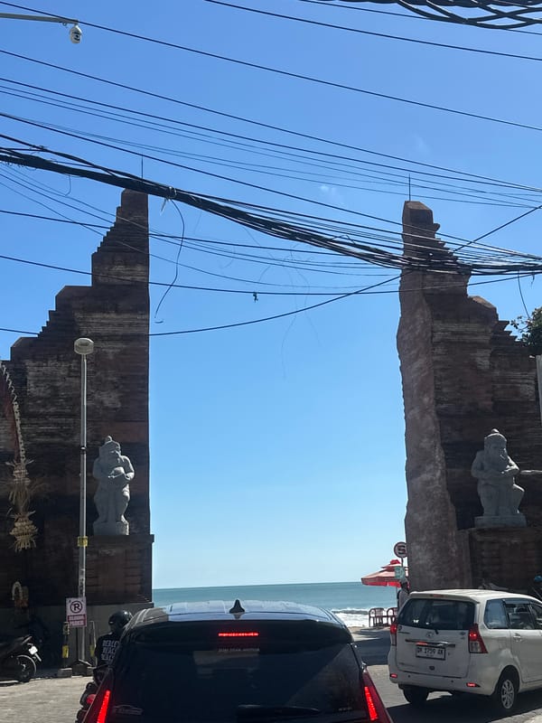 Kuta's commercial streets: traffic, vendors, and Balinese storefronts