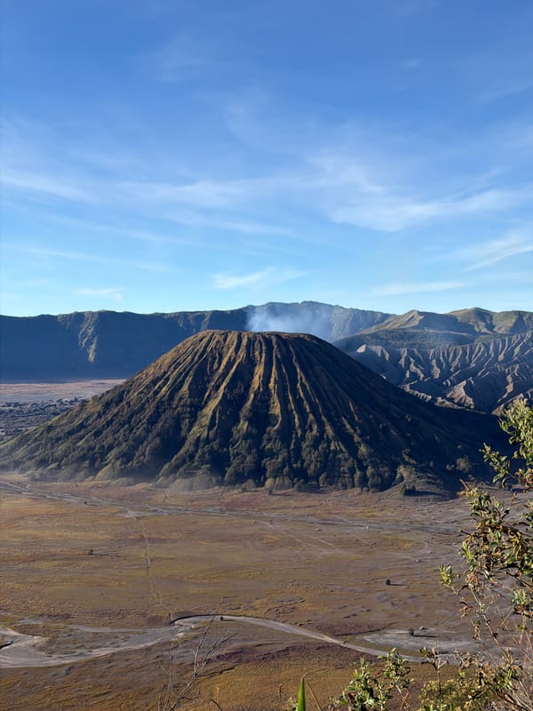 Mount Bromo's barren caldera under clear skies, Tosari