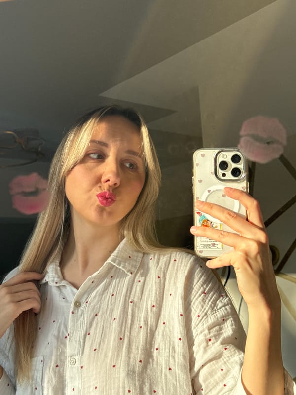 Woman takes morning selfies while styling hair in Latvia