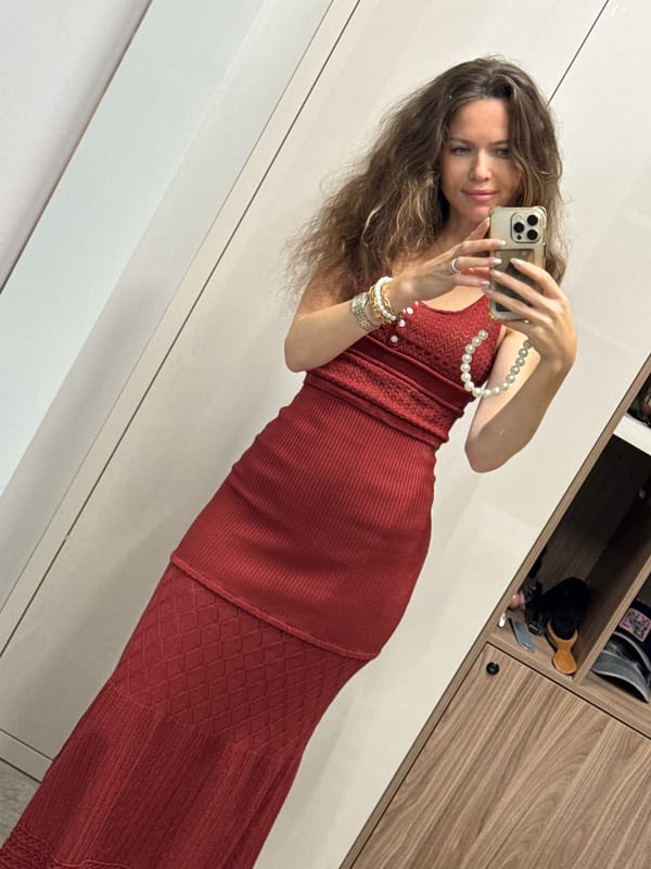 Red knit dress mirror selfies in a minimalist dressing space