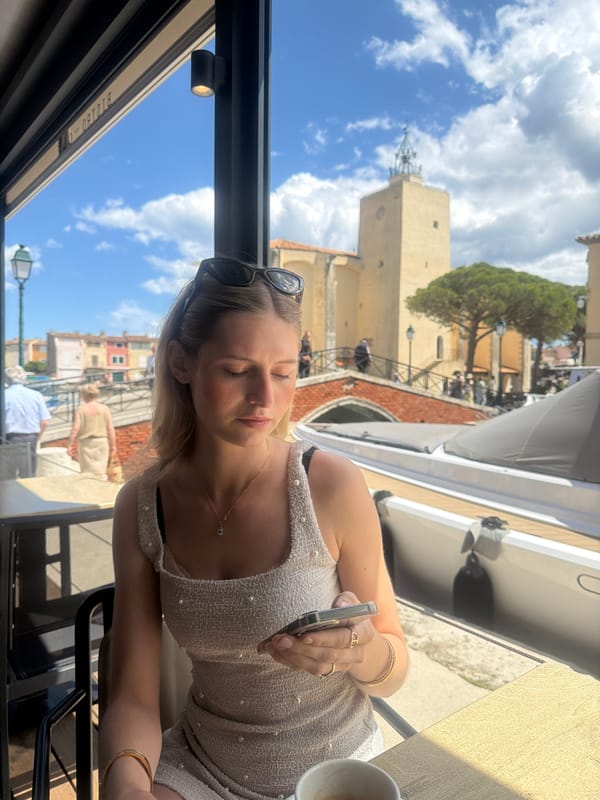Woman dines at canal-view restaurant in Grimaud, France