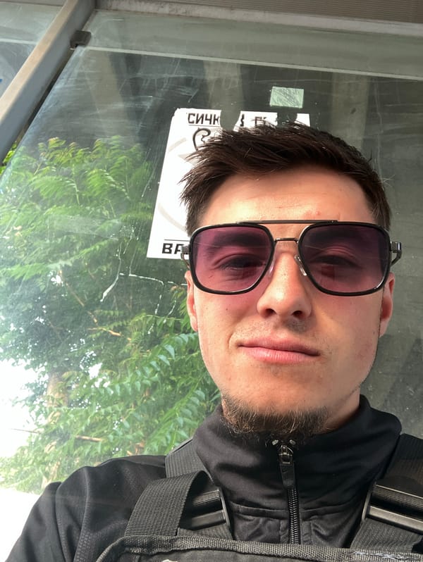 Man smokes cigarettes at Plovdiv bus stop early morning