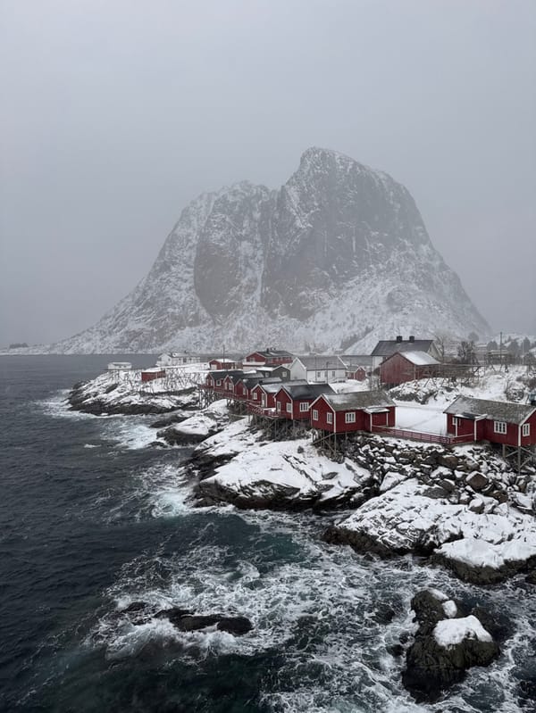 Snowplow clears roads during snowfall in Norwegian coastal village